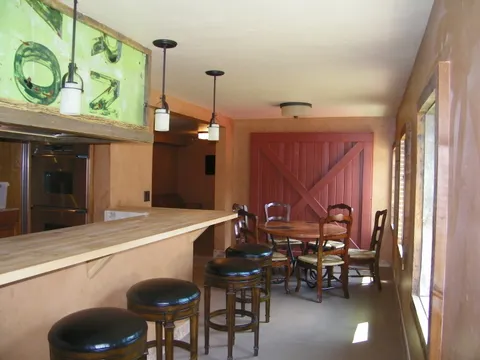 Farmhouse round table beside a red barn-style accent door