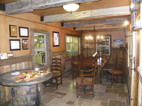 Long dining table and iron chandelier in a barn-wood dining hall