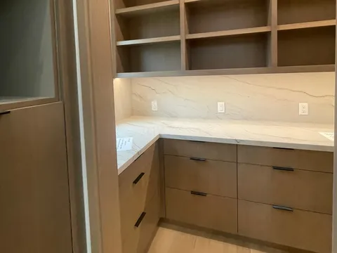 Built-in shelves and countertop nook beneath a window