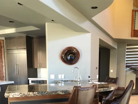 Kitchen island with a granite counter and leather bar stools
