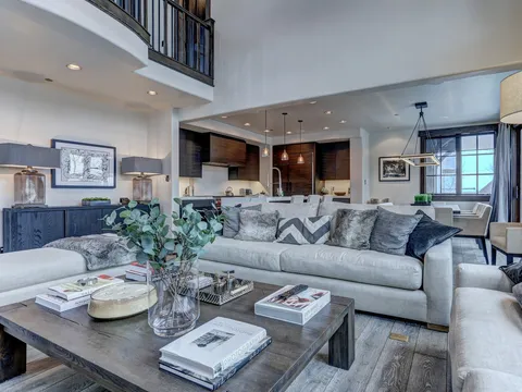 Open living room with a sectional sofa and a view into the kitchen