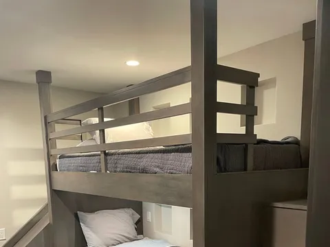 Built-in bunk beds with dark wood frames and drawers