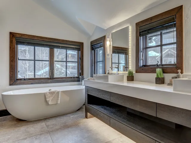 Primary bathroom with a freestanding tub and dual vessel-sink vanity