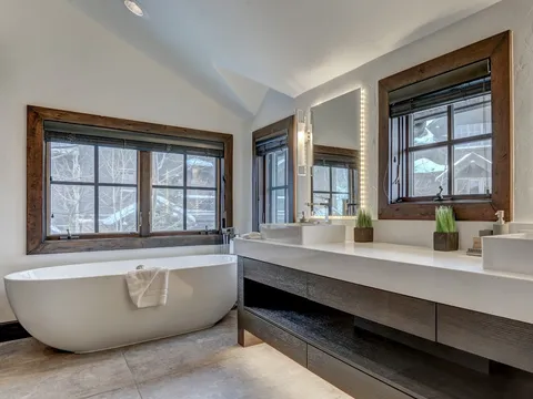 Primary bathroom with a freestanding tub and dual vessel-sink vanity
