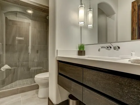 Bathroom with a tiled walk-in shower and a floating wood vanity
