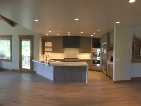 Open-concept kitchen with a wraparound island and stainless appliances
