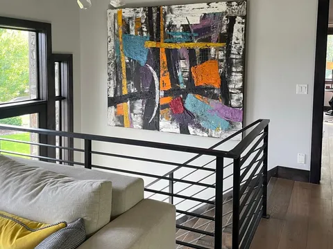 Loft lounge with a metal railing and colorful artwork